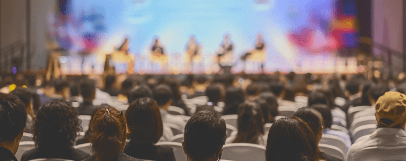 content-page image of audience watching a panel session