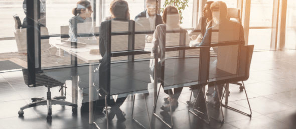 team sitting at a conference room table