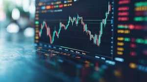 A close-up of a digital stock market chart on a computer screen, showing fluctuating candlestick patterns and various colored data points, representing market trends and financial activity.